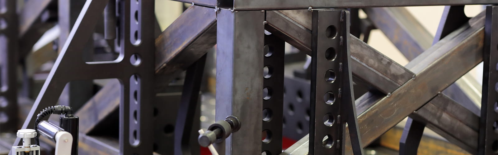 Square steel box section frame clamped on a welding table during a DIY furniture build